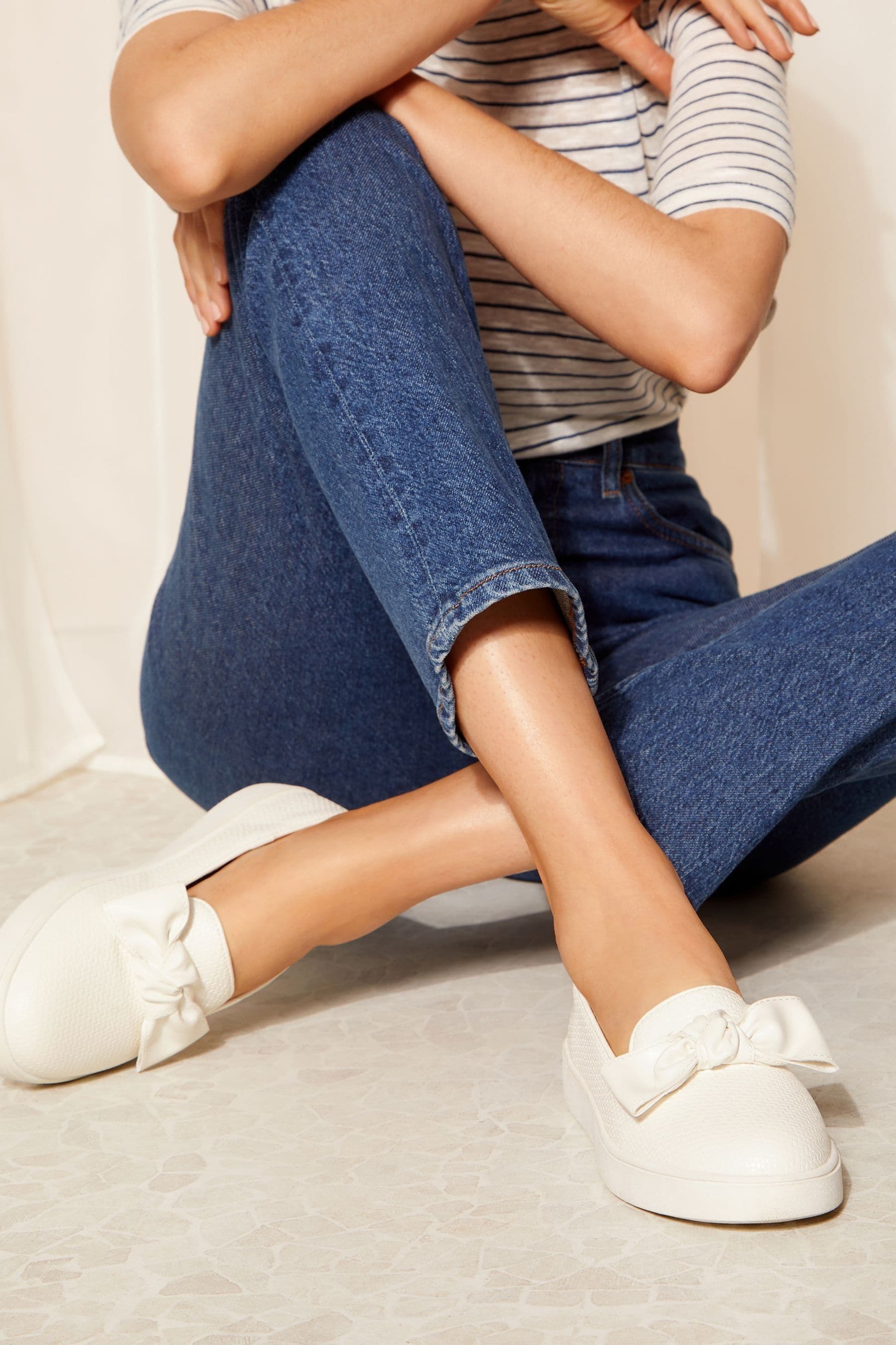 Buy Friends Like These White Regular Fit Faux Leather Bow Slip On Trainers from Next Luxembourg