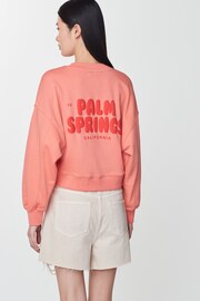 Coral Red Palm Springs Long Sleeve Graphic Slogan Sweatshirt - Image 1 of 7