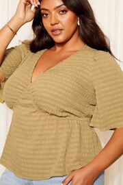 Curves Like These Khaki Green Crinkle Underbust Flutter Sleeve Peplum Blouse - Image 1 of 4