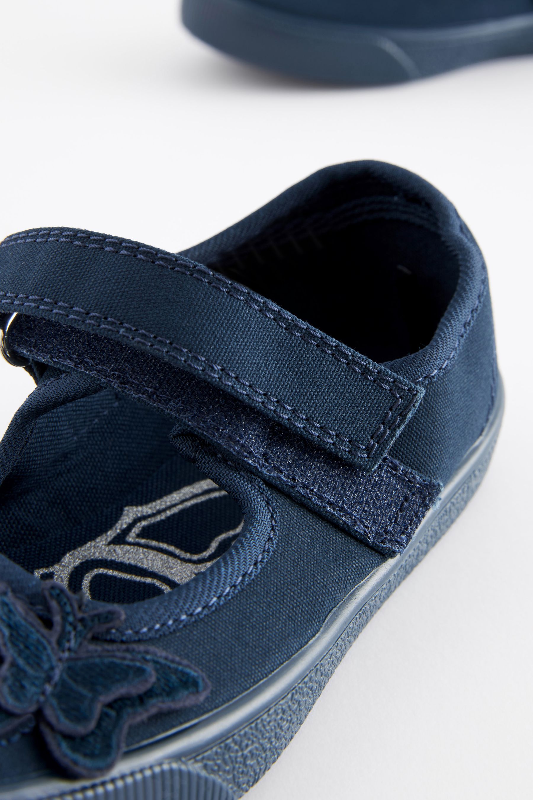Buy Navy Blue Standard Fit F Butterfly Embroidered School Plimsoll Shoes from the Next UK online shop