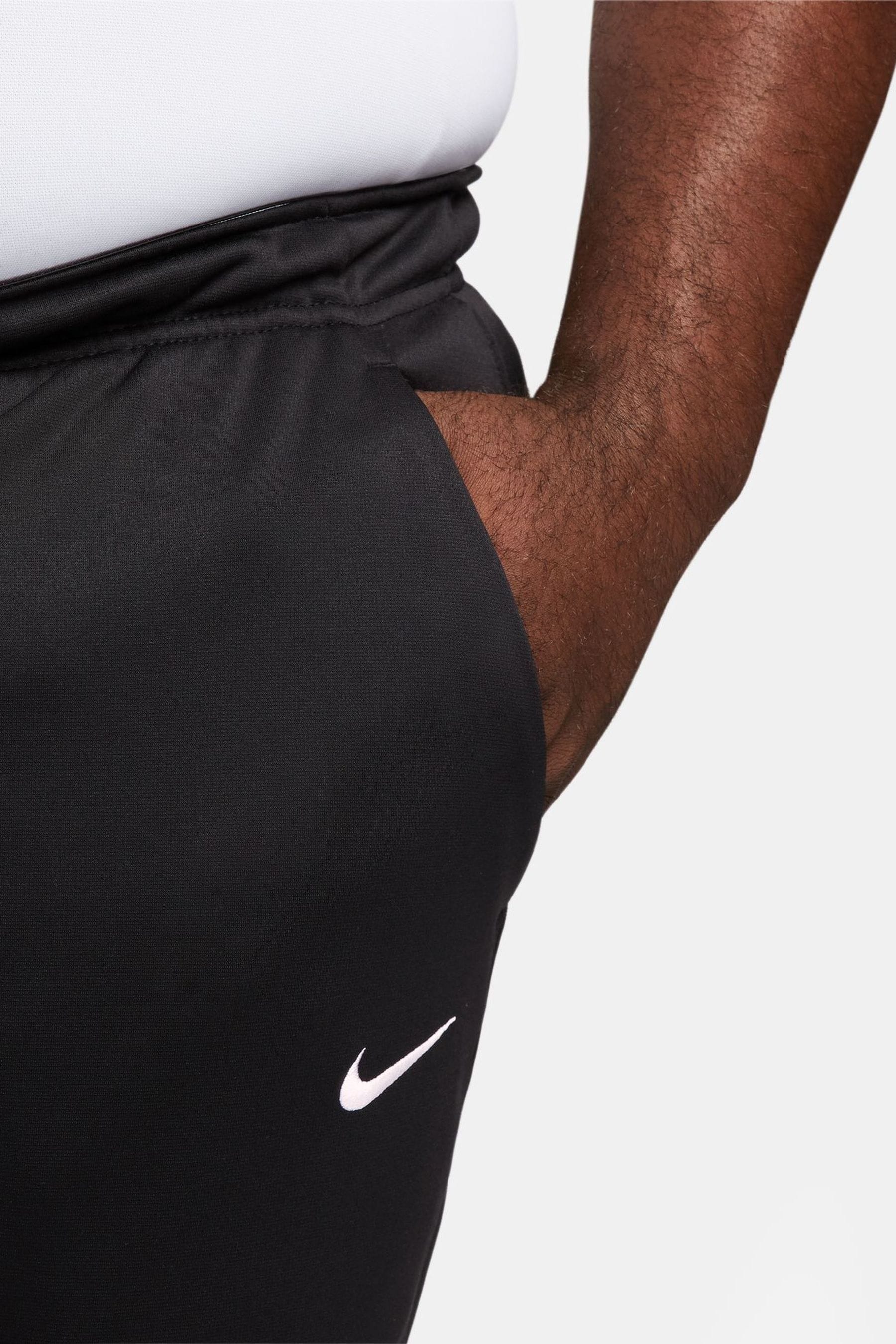 Nike training therma tapered joggers in black discount