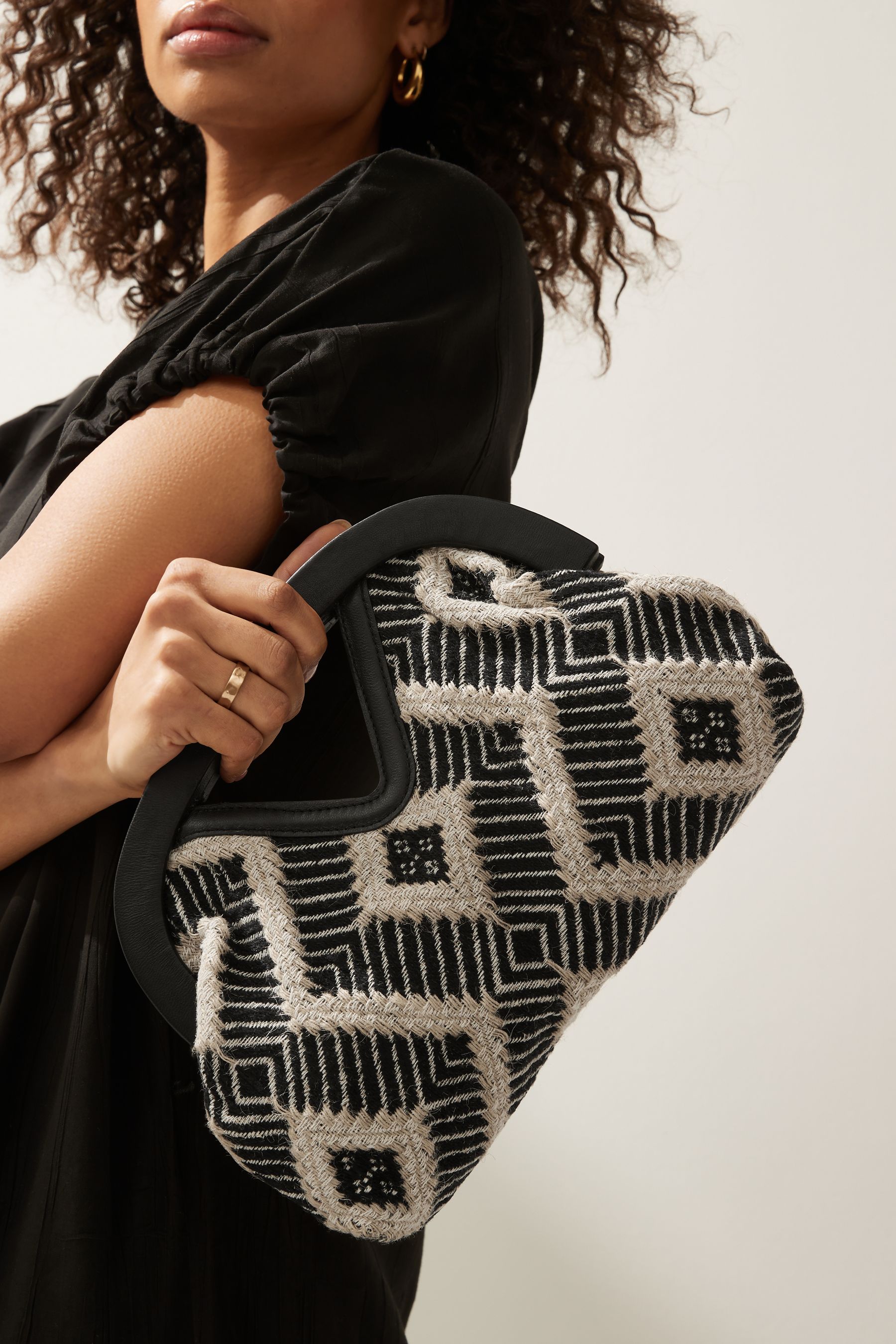 Buy Monochrome Jacquard Cut Out Handle Clutch Bag from Next Austria