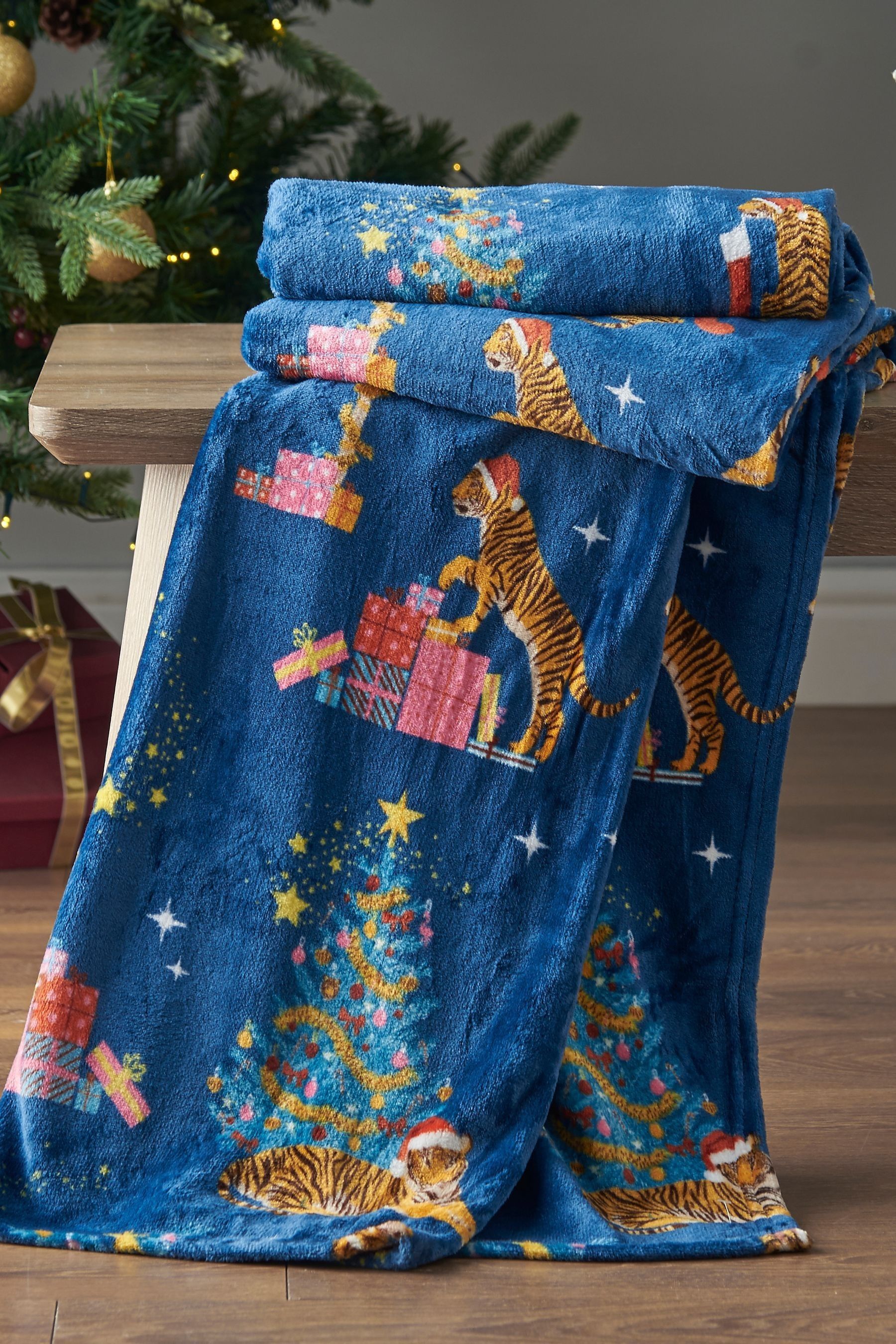 Buy Catherine Lansfield Navy Blue Christmas Tiger Print Soft and Cosy Fleece Throw from the Next UK online shop