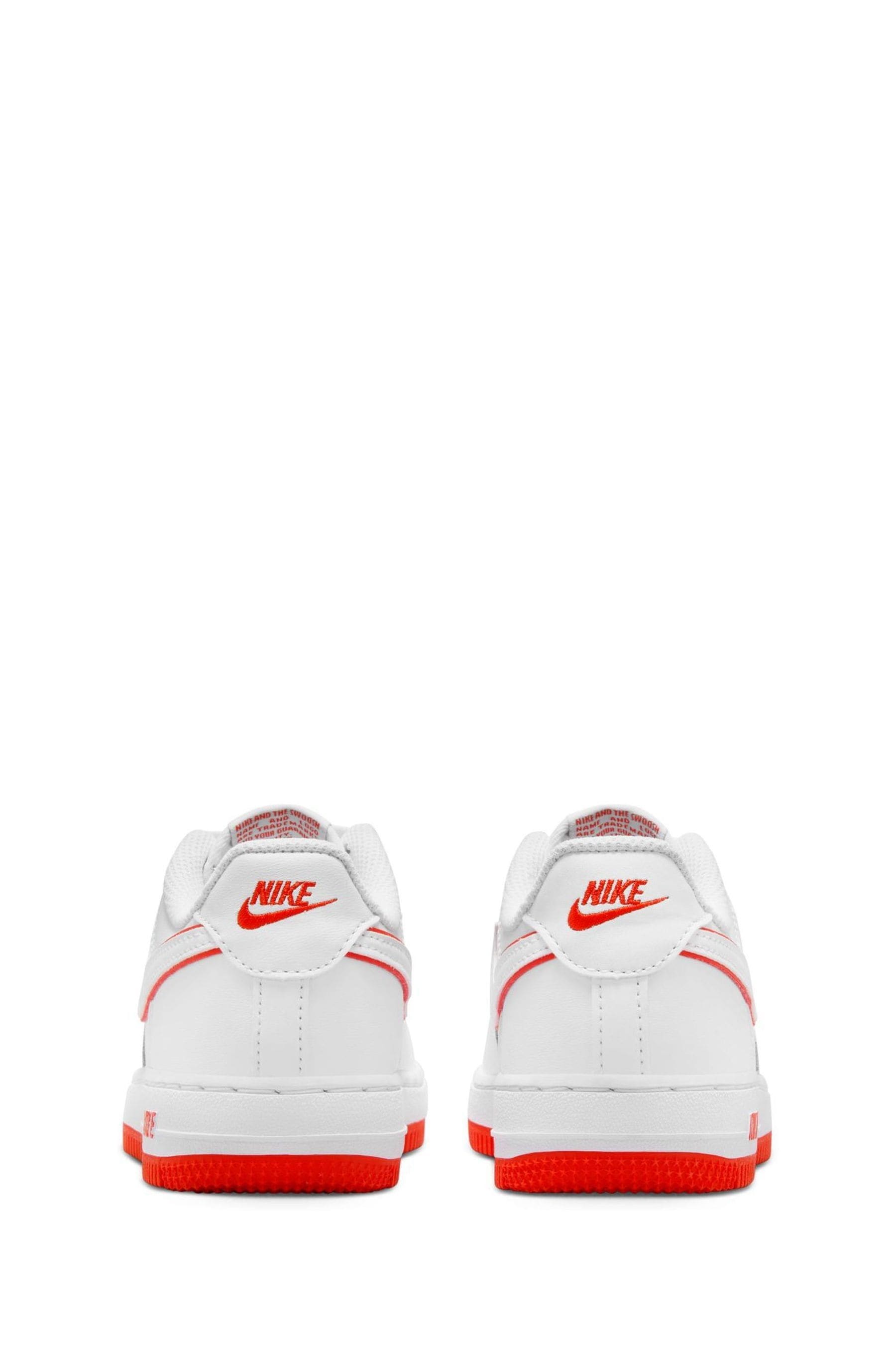 Orange and store white nike sneakers