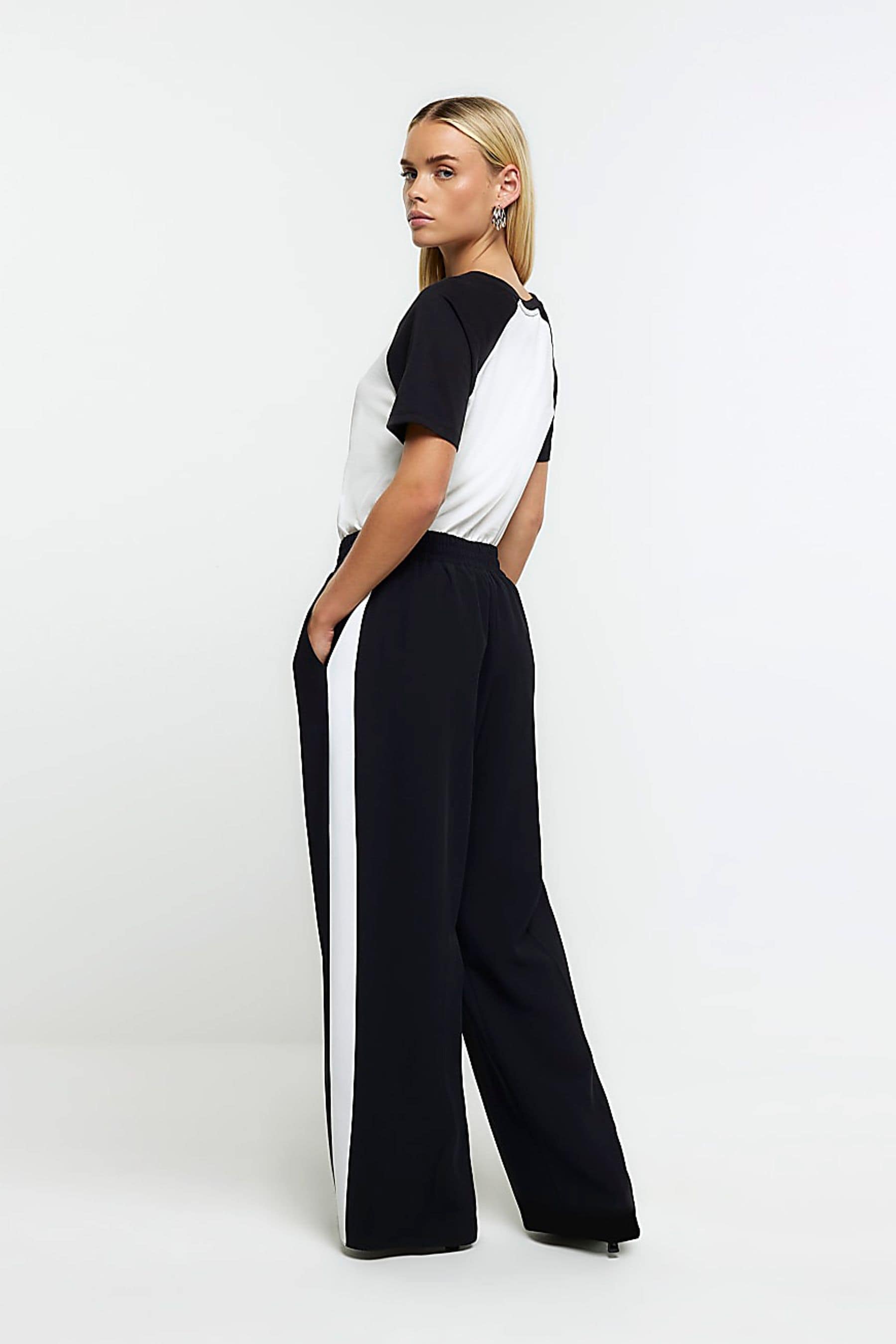 Buy River Island Black Petite Side Stripe Wide Leg Joggers from