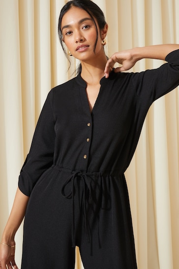 Friends Like These Black Petite Jersey Long Sleeve Cinched Waist Jumpsuit