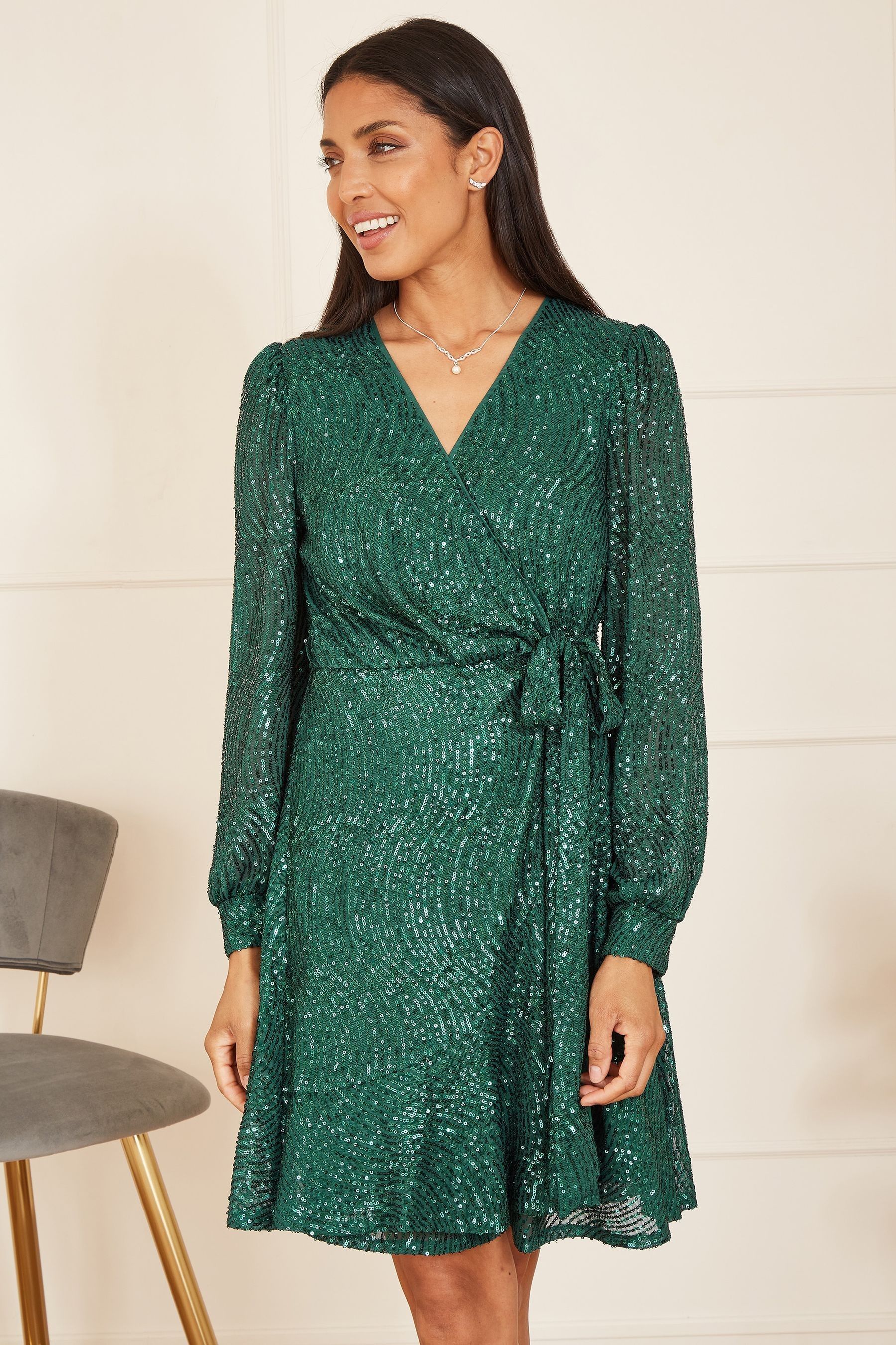 Buy Mela Green Sequin Long Sleeve Frill Wrap Dress from the Next