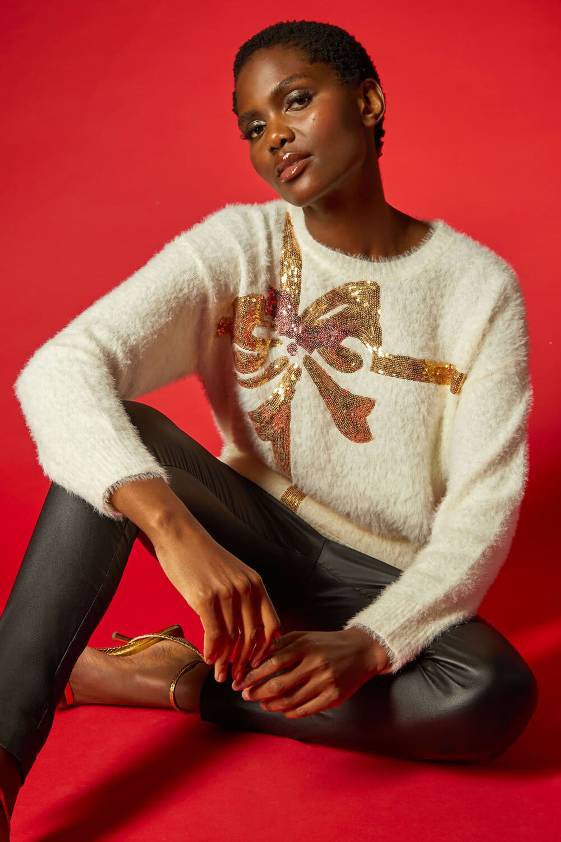 White jumper with red sale sequin bow