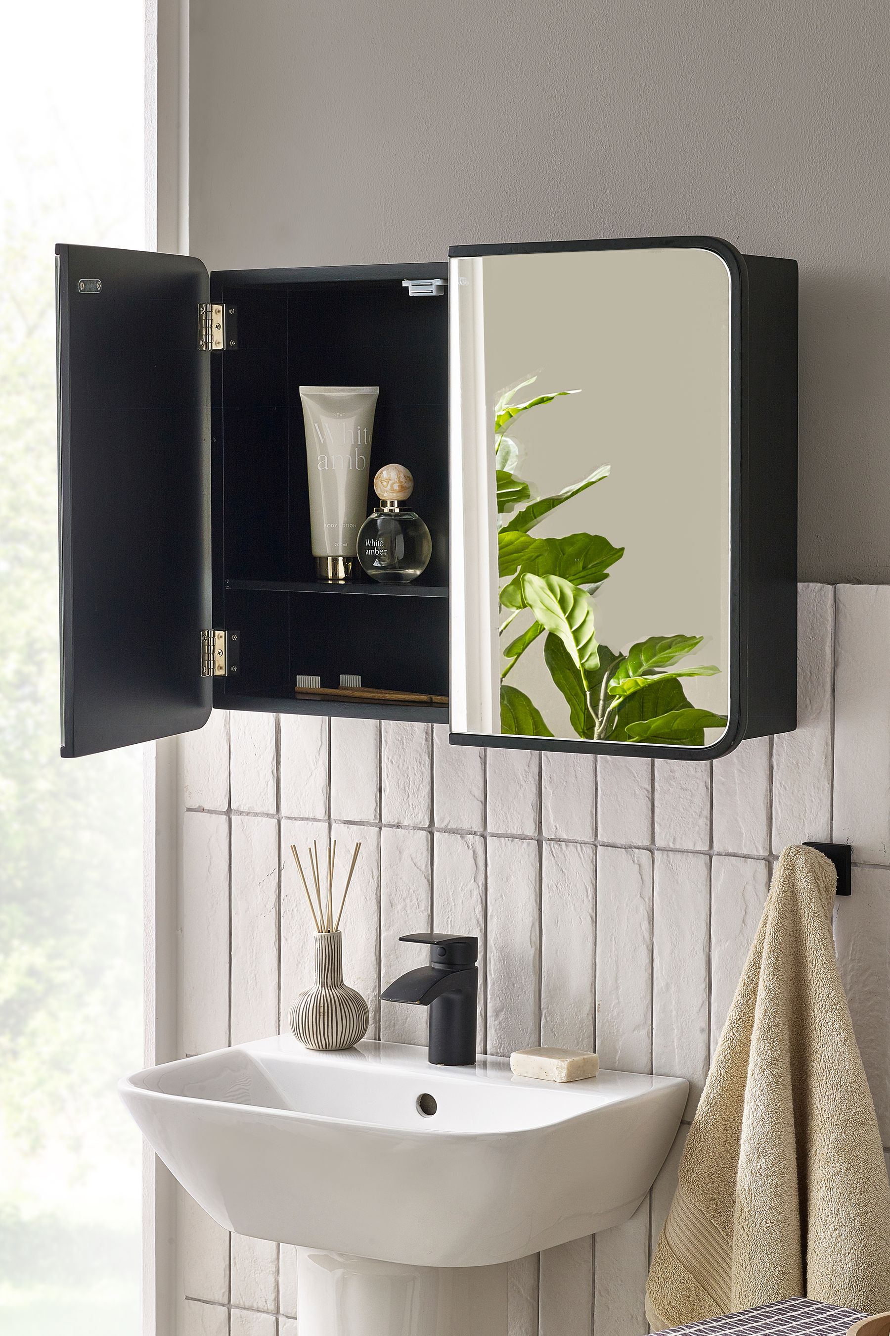 Black over outlet toilet wall cabinet