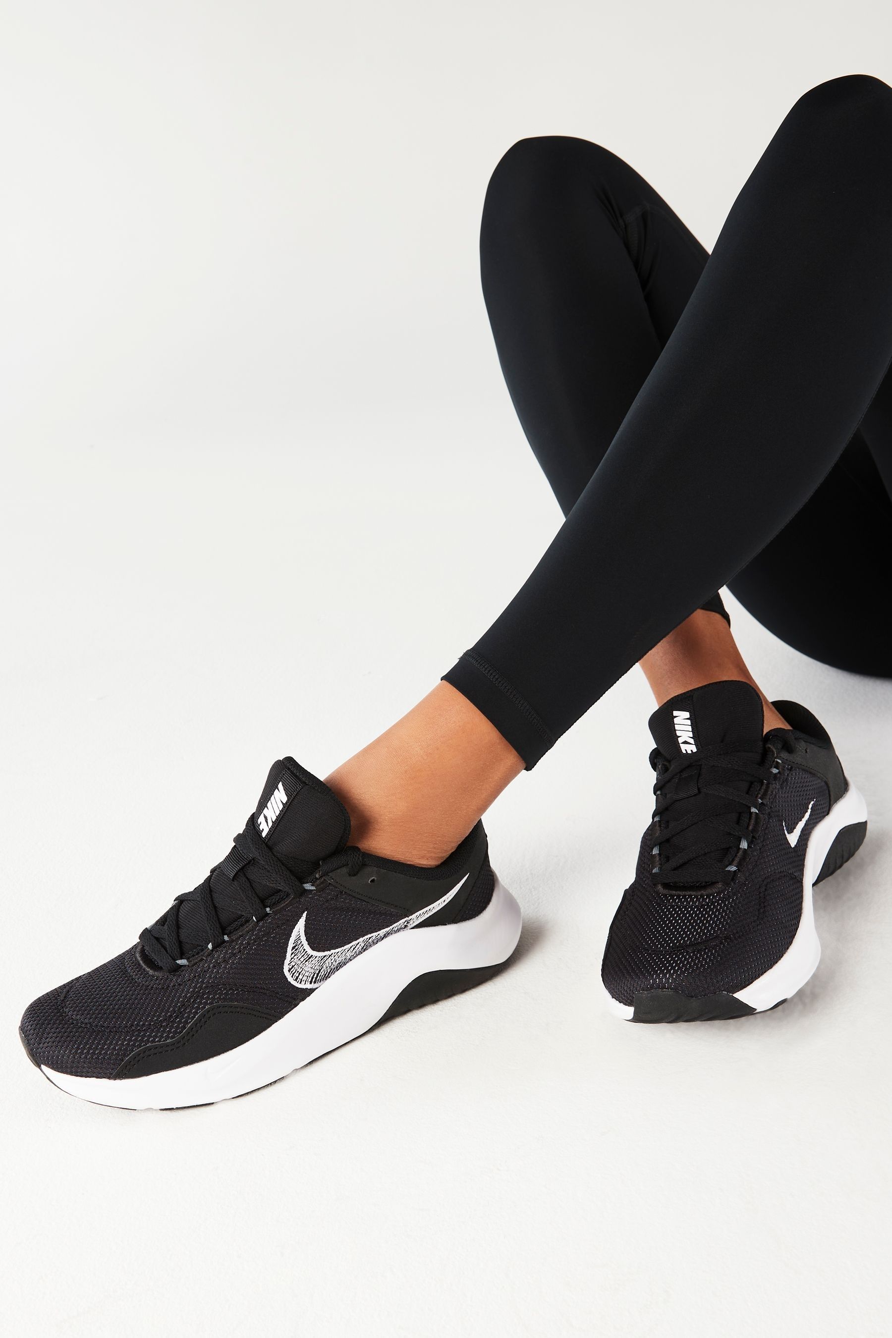 Womens black nike top trainers with white tick