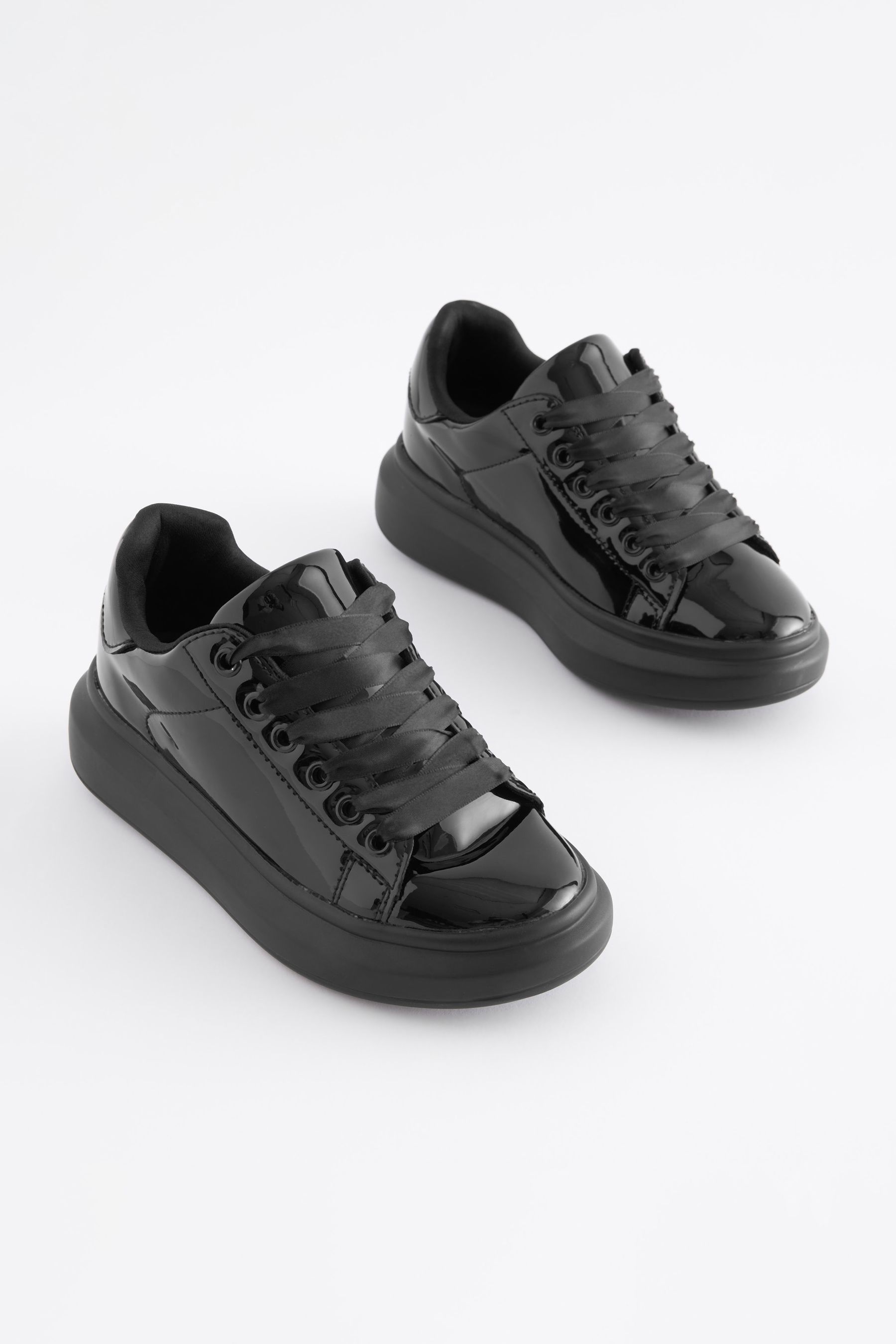 Black trainers with shop ribbon laces