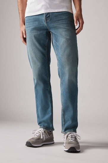 Eroded distressed denim jeans